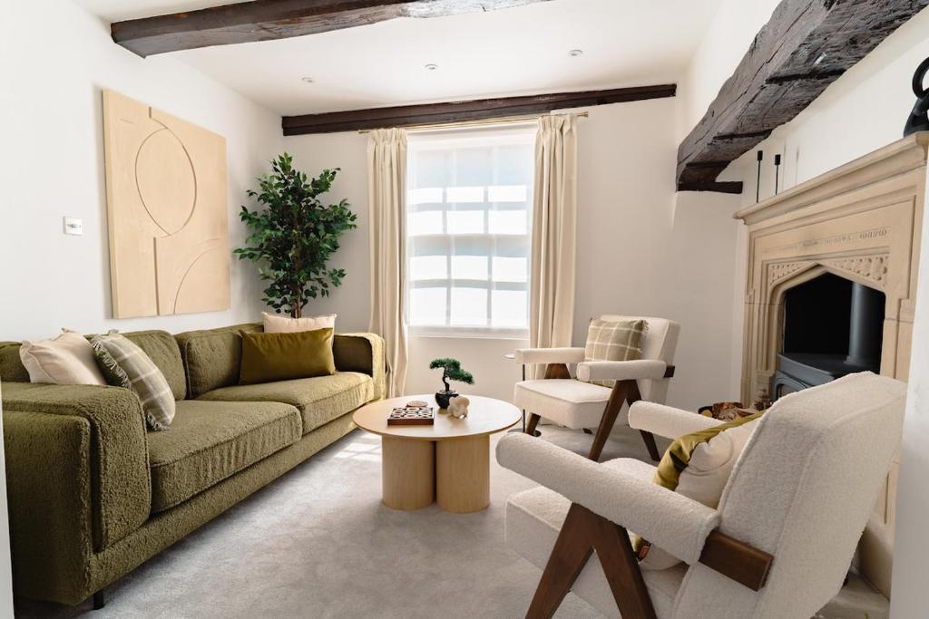 a living room with a couch and a table at St James House Timeless Comfort Central Congleton in Congleton