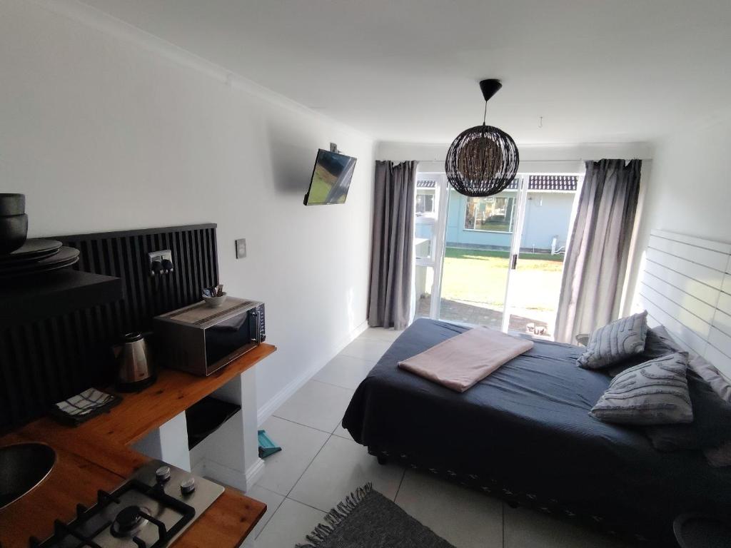 a bedroom with a bed and a television and a window at 284 on circular 3 in Sunridge Park