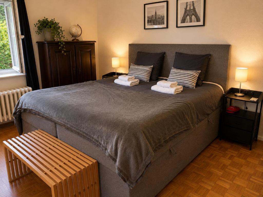 a bedroom with a large bed with two towels at Secret Garden in Waterloo