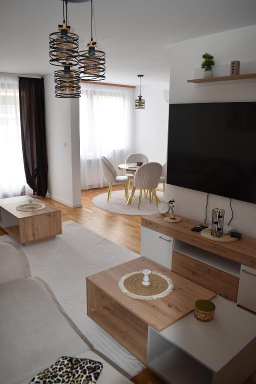 a living room with a large flat screen tv at Elite Suites - Vogošća in Vogošća