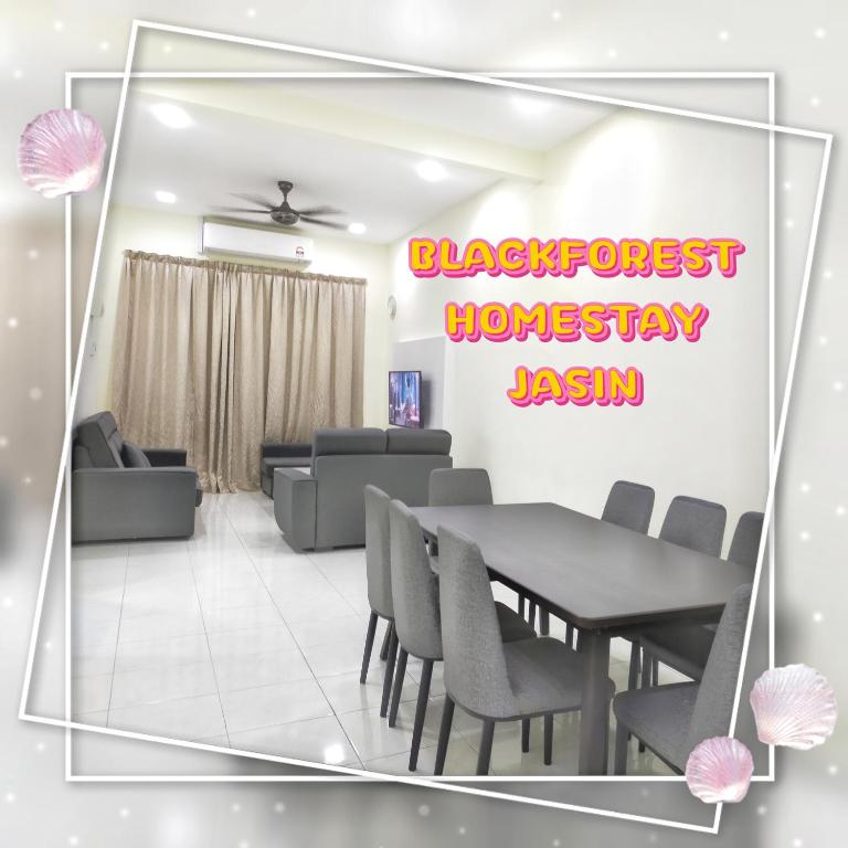a dining room with a table and chairs at HOMESTAY JASIN BLACKFOREST in Jasin