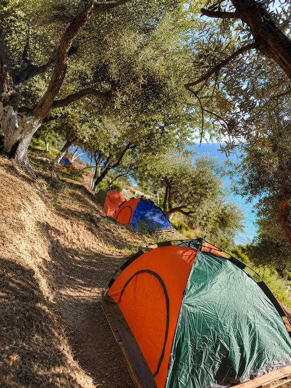 a group of tents sitting on a dirt road next to a campsite at Blue Camping in Borsh, Vlorë in Borsh