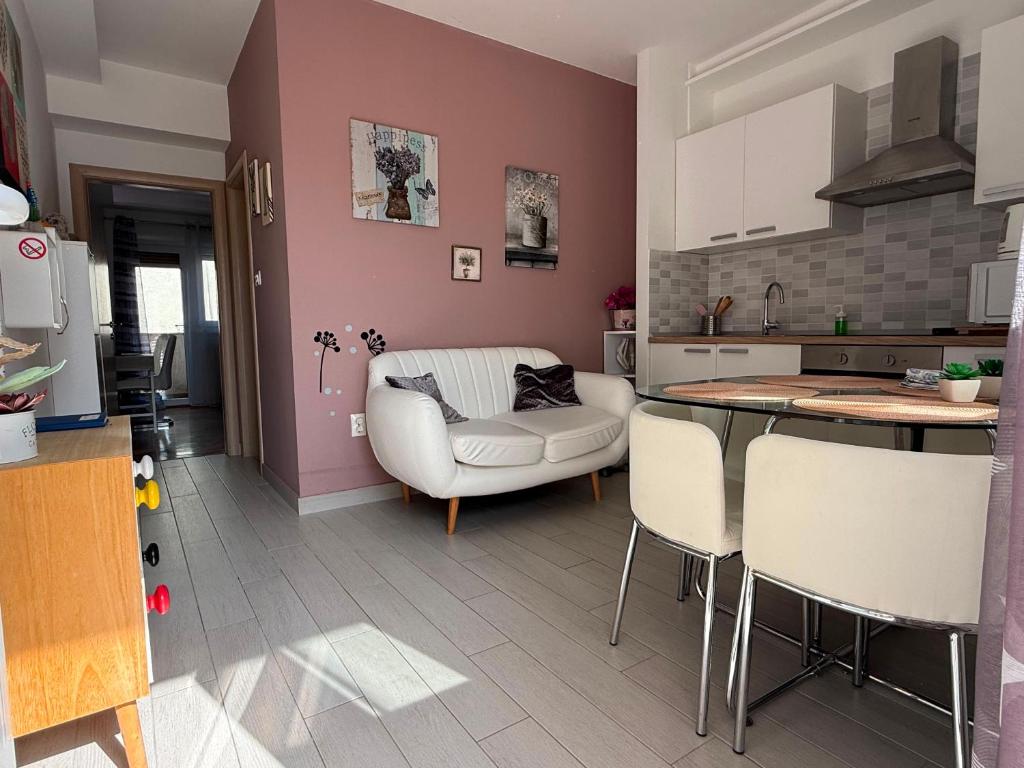 a kitchen and living room with a couch and a table at New apartment Dany with parking for two in Split