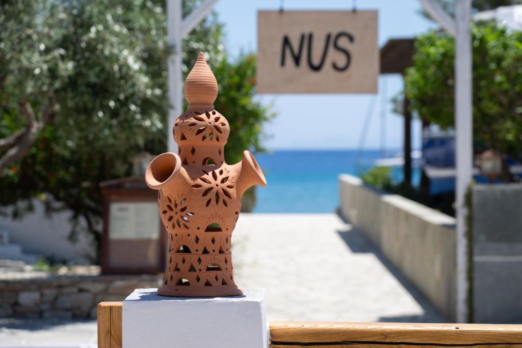 a wooden figurine sitting on a table in front of a sqor at À La Plage Residences 03 in Platis Gialos