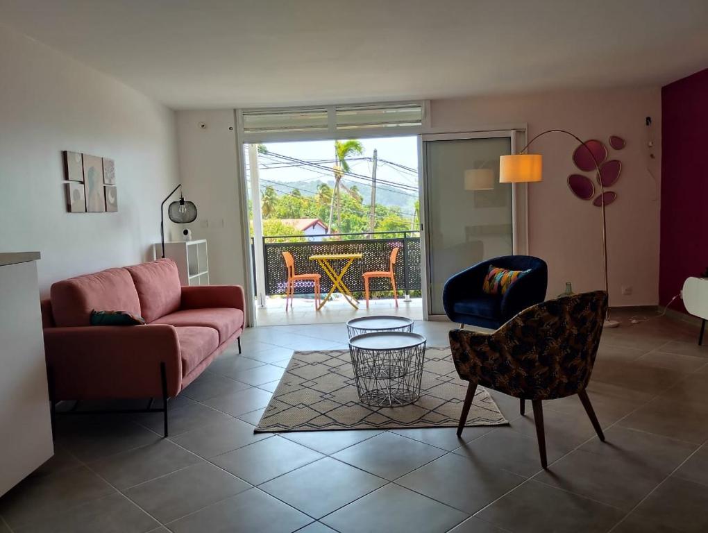 a living room with a couch and a table at La terrasse de Bonne terre in Saint-Claude