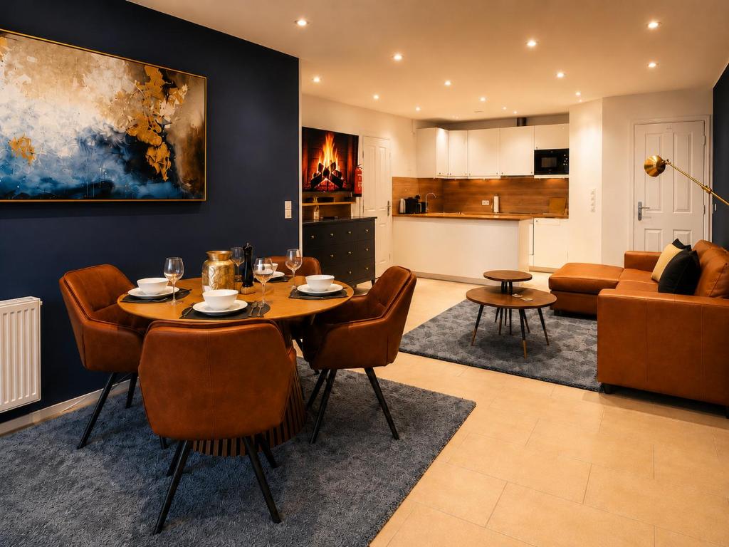 a dining room and living room with a table and chairs at Luxury Apartment Königsallee Old Town Rhine Promenade Messe in Düsseldorf
