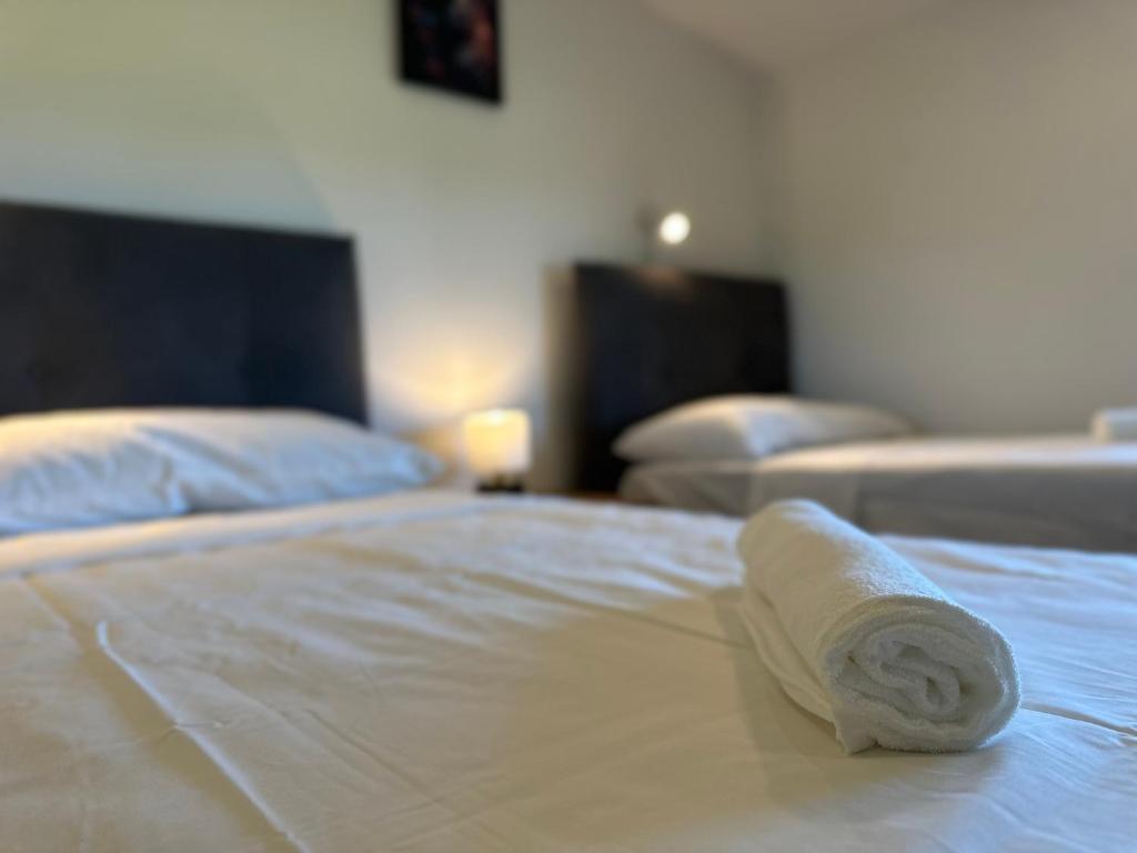 a rolled up towel sitting on top of a bed at Venice Airport House in Venice