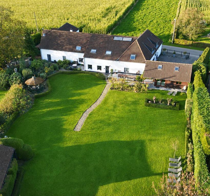 an aerial view of a house with a large green yard at Het Hemelsveld in Hasselt