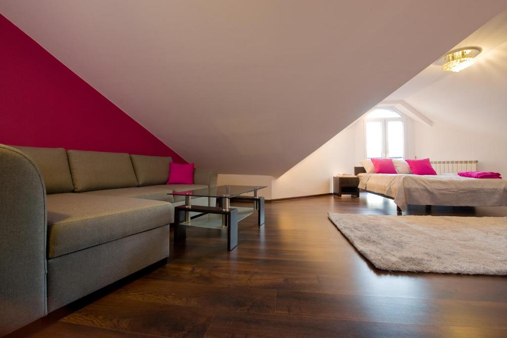 ein Wohnzimmer mit einem Sofa und einem Tisch in der Unterkunft Hostel & Restauracja Santorini in Białystok