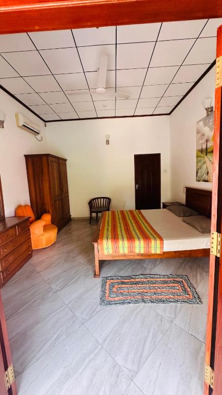 a large room with a bed and a table at Chamo Villa by DrMocktail in Beruwala