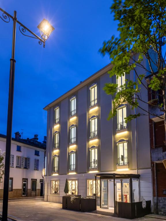 a building with a street light in front of it at Hotel de La Ville - Self Check-In in Fidenza