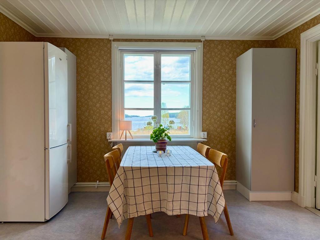a dining room with a table and a window at Boende i Sandarne in Sandarne