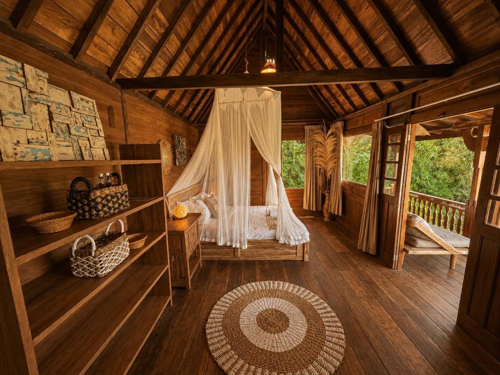 a room with a bed in a wooden house at Zen Tree House in Silebeng