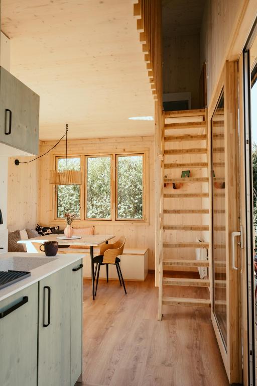 a kitchen with a staircase in a tiny house at Mokuzo Tiny Houses in Lauingen