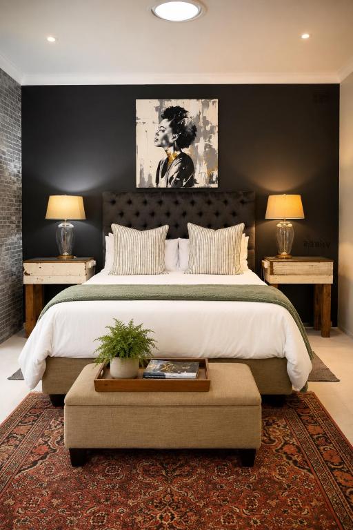 a bedroom with a large bed and two night stands at Art-Inspired Bedroom Close to CBD in Mossel Bay
