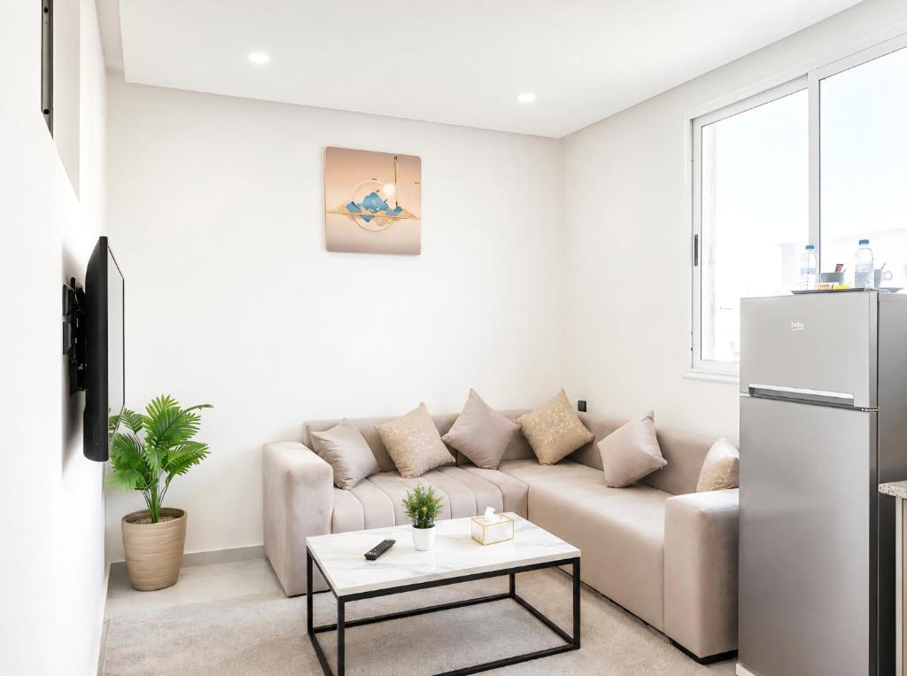 a white living room with a couch and a table at S1 Modern & Relax in Agadir