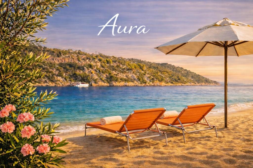 two chairs and an umbrella on a beach at Aura in Gerakini