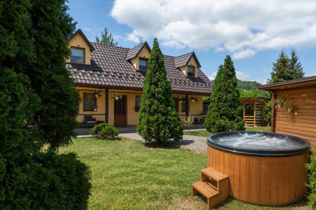 a house with a hot tub in the yard at Cabana Viilor Dej in Dej