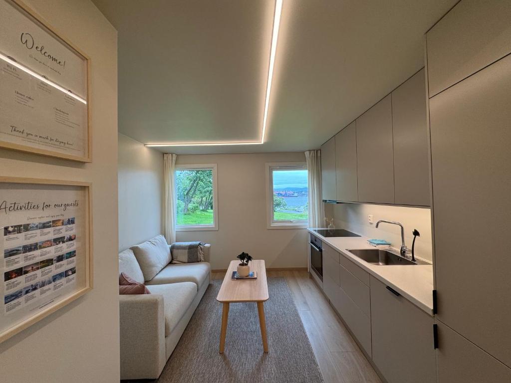 a living room with a couch and a table at Parkside apartment in Narvik