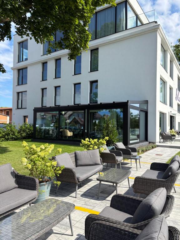 a group of chairs and tables in front of a building at BULVAR boutique in Dziwnów