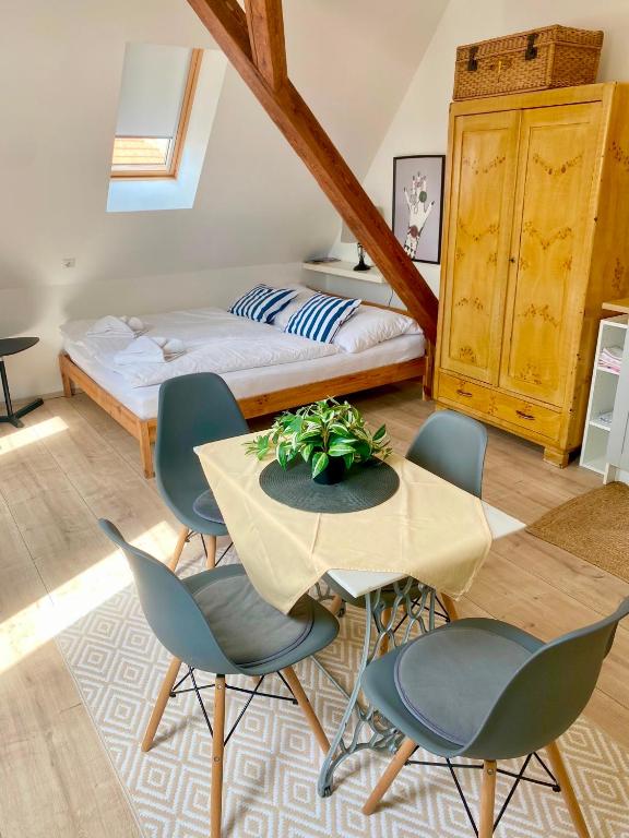 a room with a table and chairs and a bed at Apartmány Lednice in Lednice