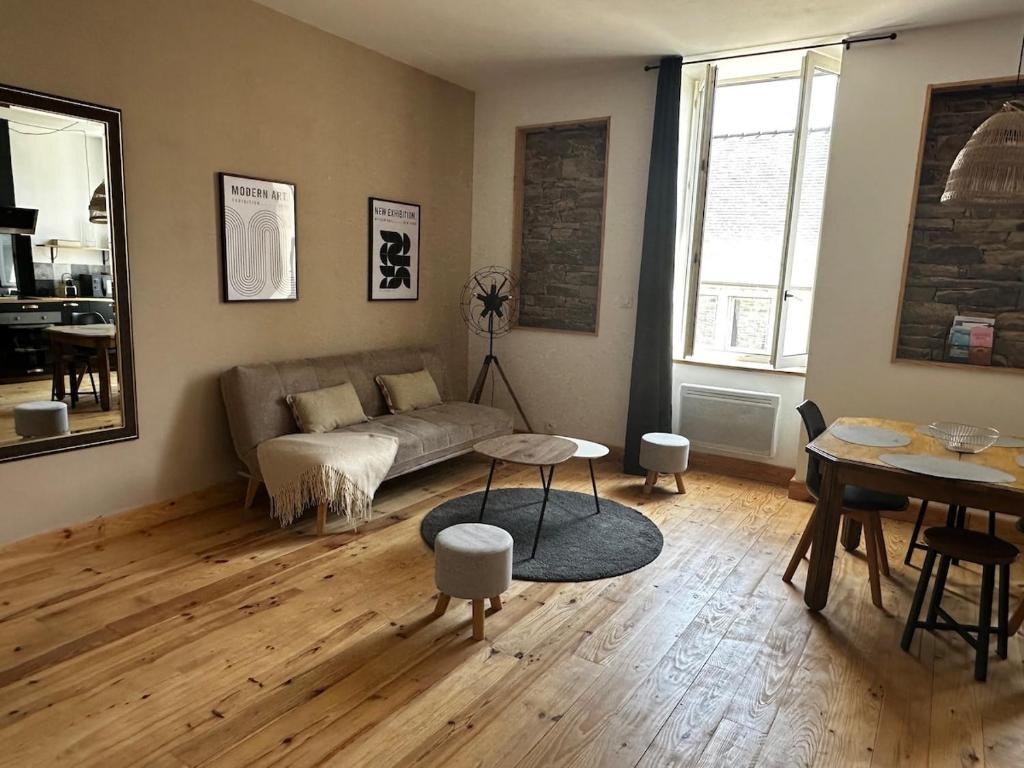 a living room with a couch and a table at Molène Centre Ville Lannion in Lannion