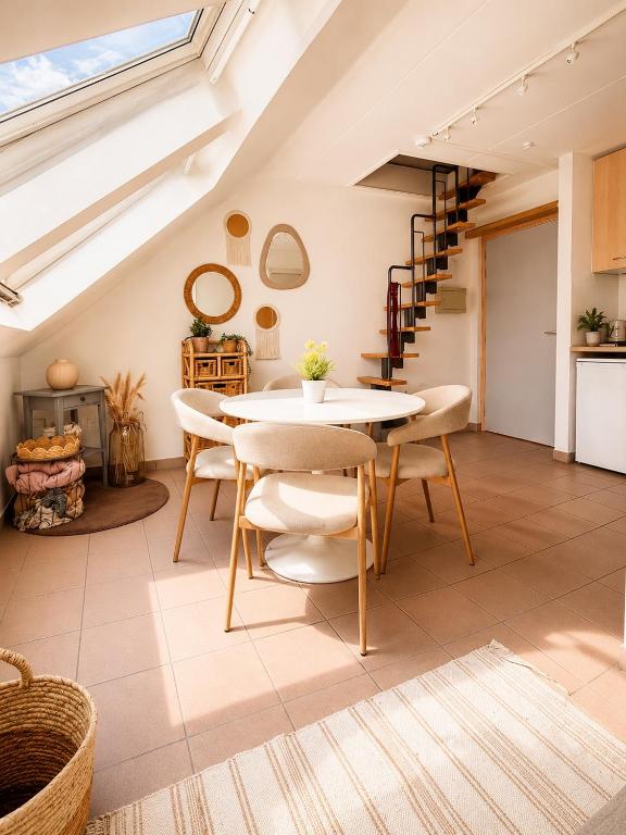 a kitchen and dining room with a table and chairs at Cozy duplex apartment with free parking in Leuven