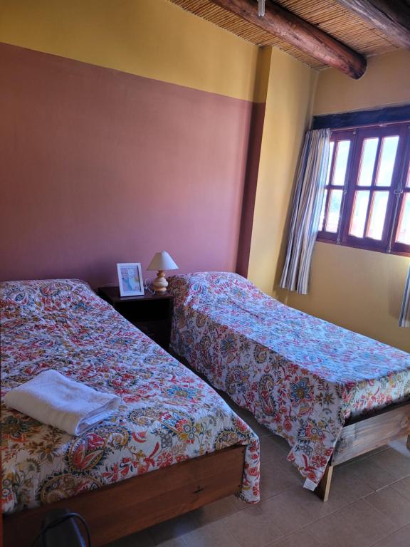 a bedroom with two beds and a window at WasyLopez in Maimará