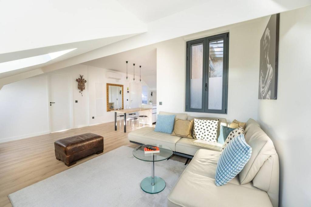 a living room with a couch and a table at Monte Carlo Monaco Border - luxury, modern, cozy with home feelings and See View in Beausoleil