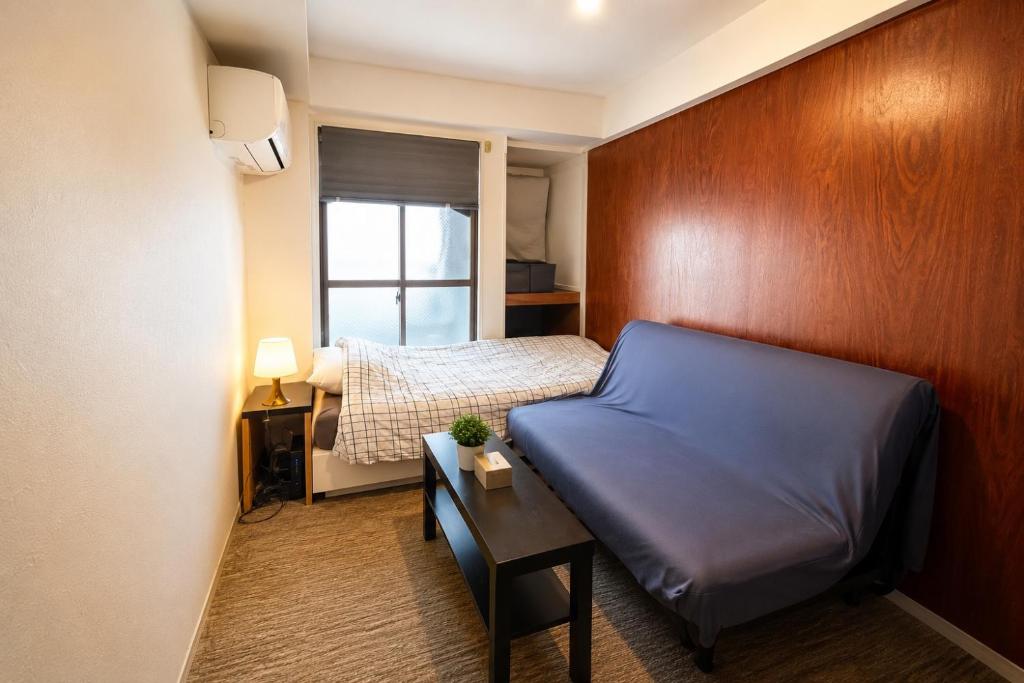 a small bedroom with a bed and a window at あびこ202 WEST WOOD GUEST ROOM Petといっしょに宿泊可能 in Osaka