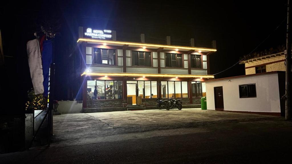 a building with lights on top of it at night at Hotel Marpha Comfort And Restaurant in Tukucha