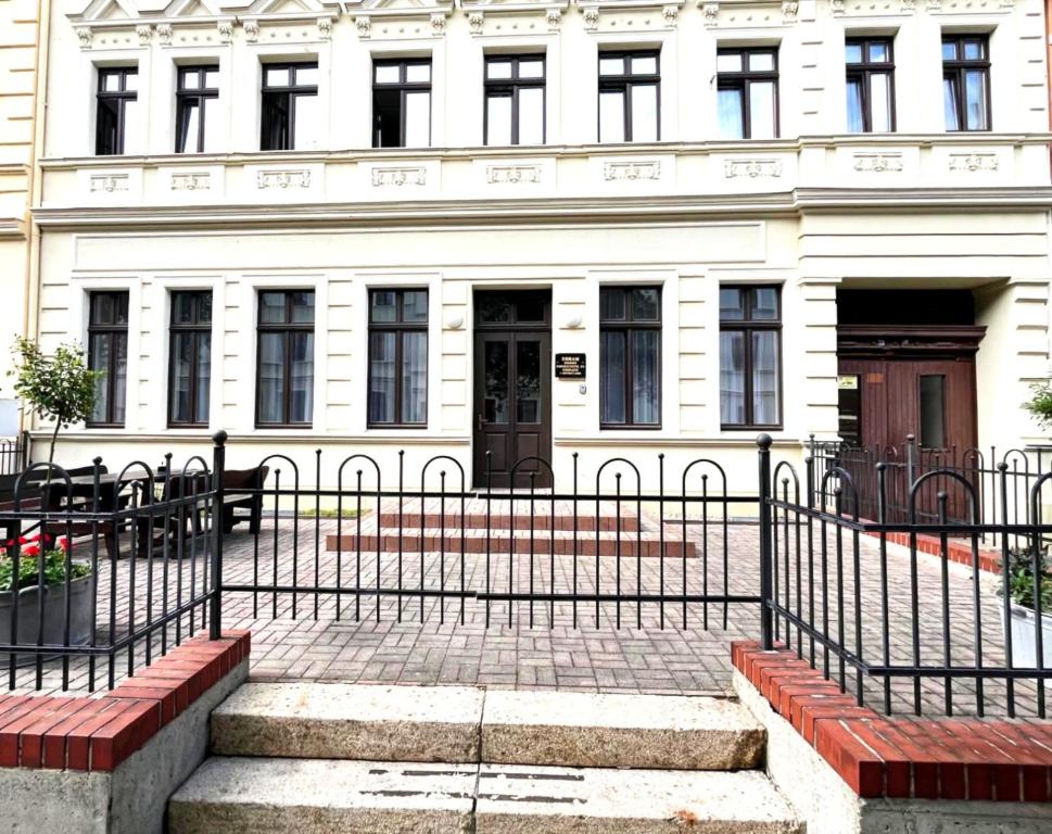 a building with a gate and stairs in front of it at EBRAM II Apartments Görlitz in Görlitz