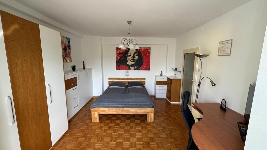 a bedroom with a bed and a desk at Nice Studio Apartment in Gumpoldskirchen