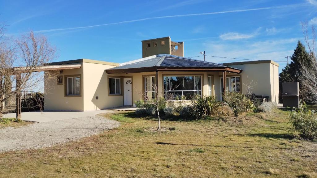 a house with a clock tower on top of it at APA Las Condalias in Puerto Madryn