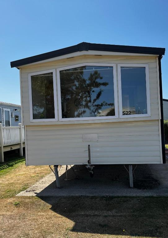 a tiny house on a stand in a yard at 22 seabreeze holiday park in Hemsby