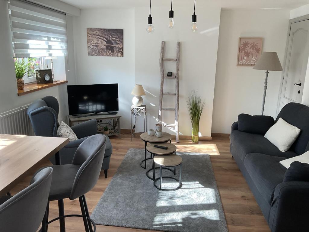 a living room with a couch and a table at Au fil de la Semois in Bohan