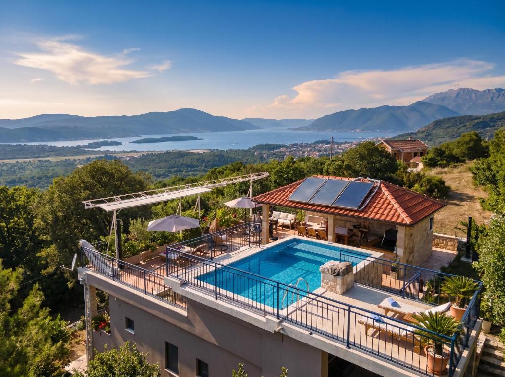 an aerial view of a house with a swimming pool at Villa Dobric Apartments in Kavač
