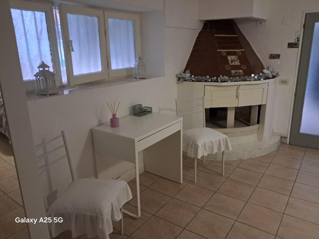 a living room with a desk and a fireplace at Appartamento Catini 67 in Civitavecchia