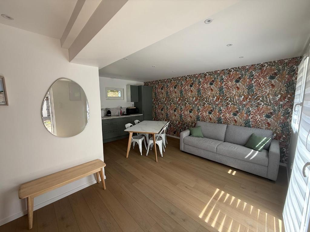 a living room with a couch and a table at Chtî arq in Arques-la-Bataille