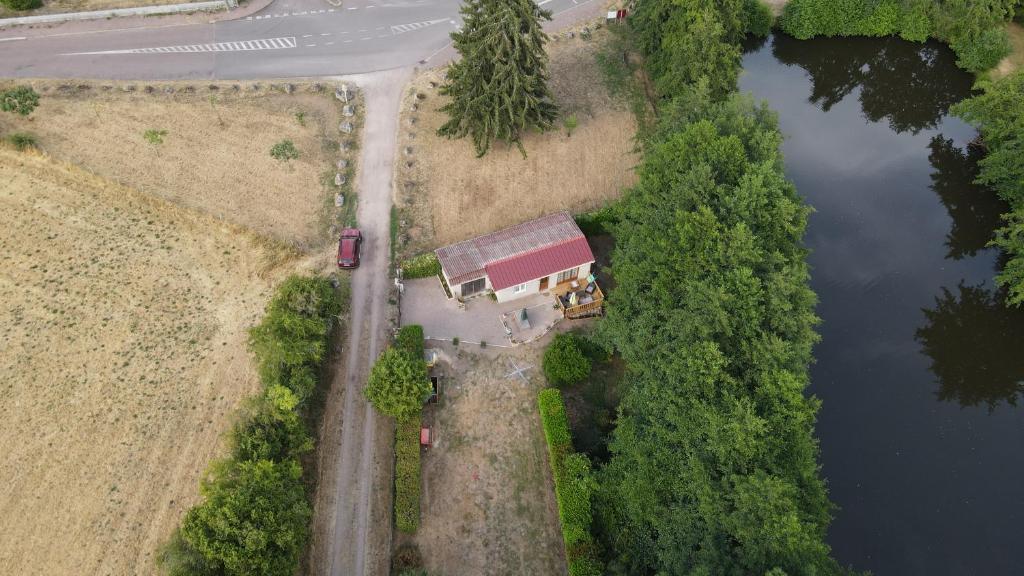 an aerial view of a house next to a lake at Gite du Tacot 21 in Saulieu