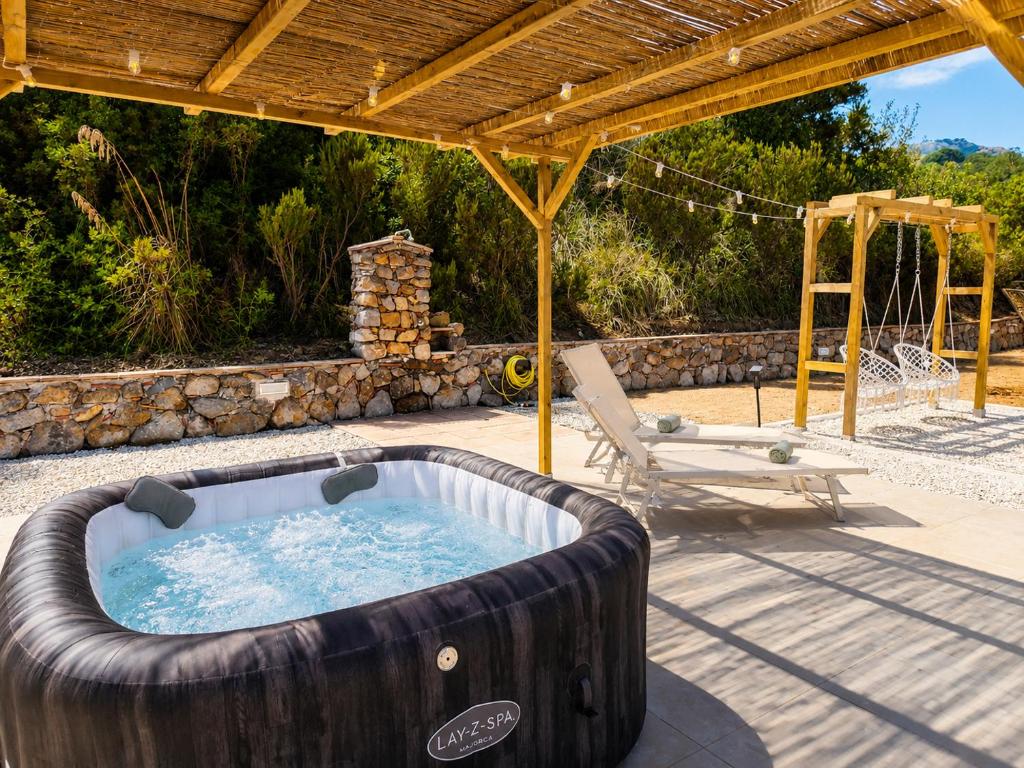 a large wooden bath tub sitting on a patio at Reale Home in Casa Tonietti