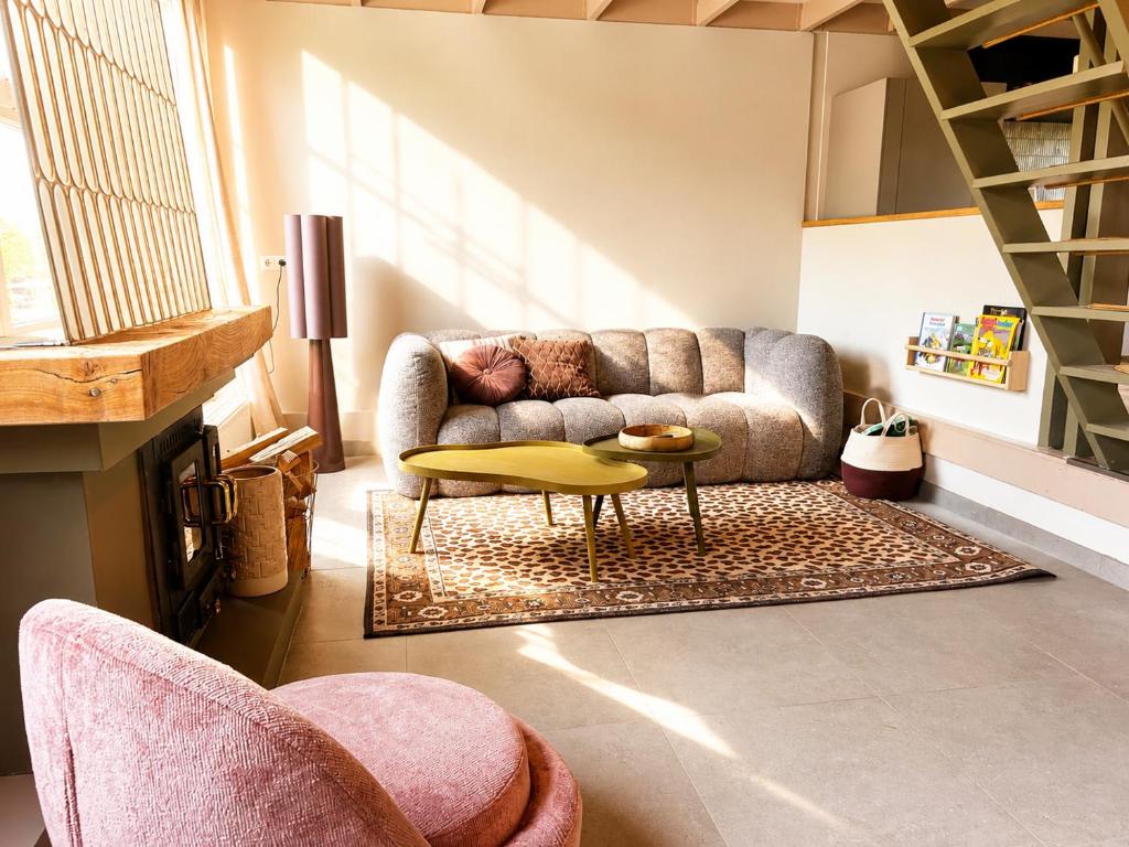 a living room with a couch and a table at De Kustwacht in Warmenhuizen