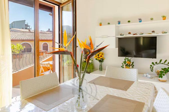 a living room with a vase with flowers on a table at Il Girasole - Appartaments in Domus de Maria