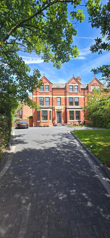 a large red brick building with a driveway at Victorian Renovation Room 5 in Liverpool