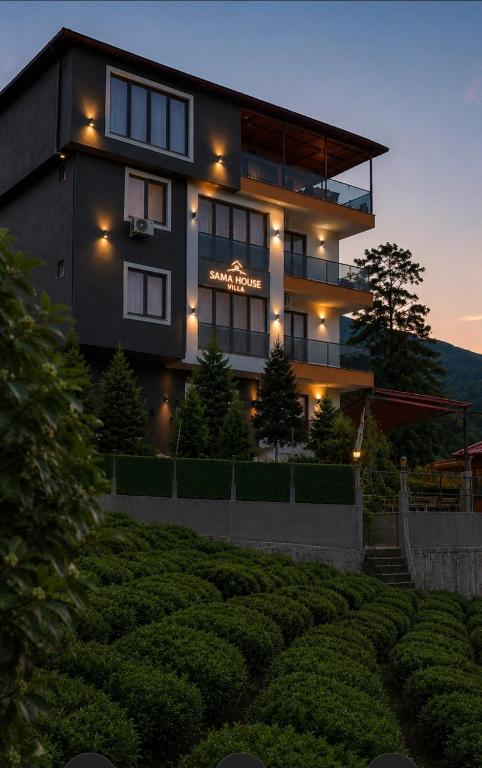 a large building with a lot of lights on it at Sama house in Rize