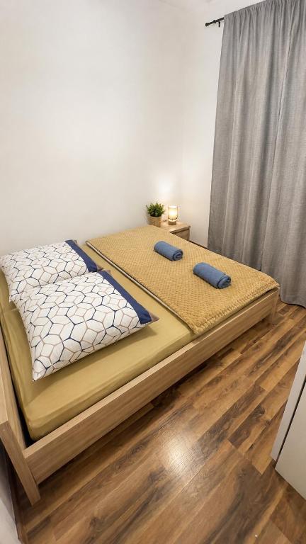 two beds in a room with wooden floors at Ametystowa Street in Września