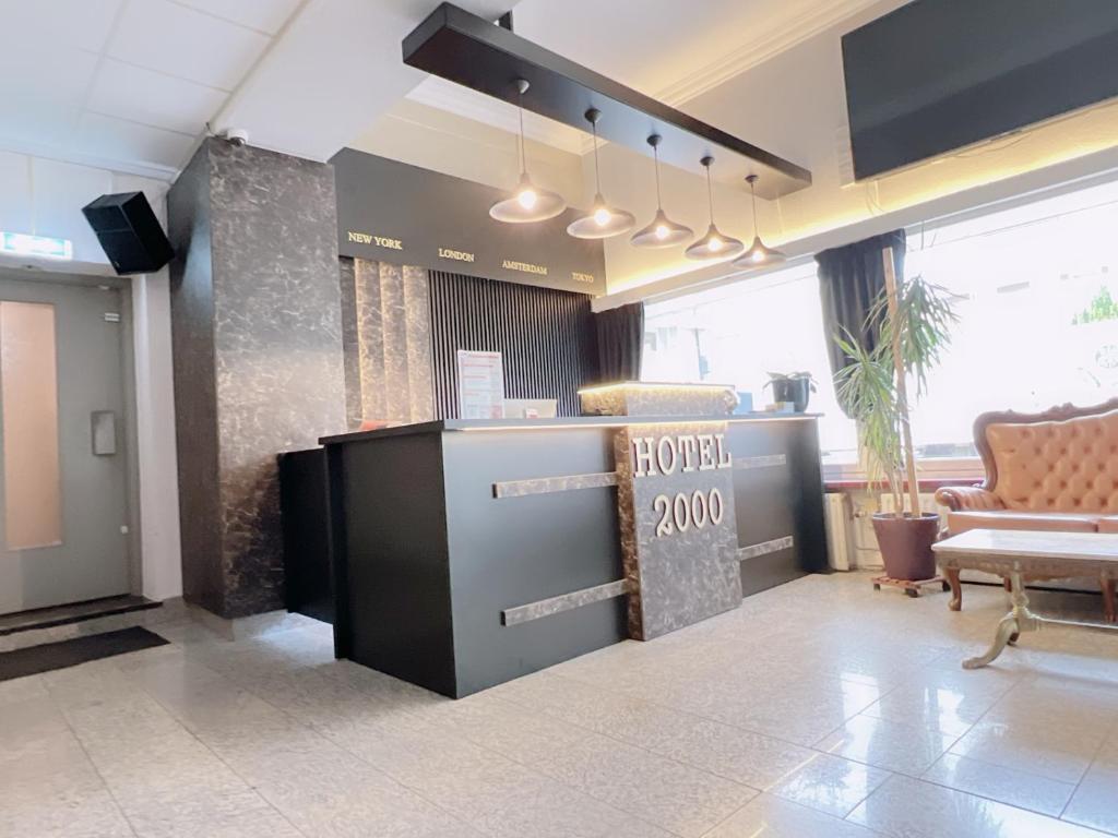 a lobby with a hotel sign on the wall at Hotel 2000 Valkenburg in Valkenburg