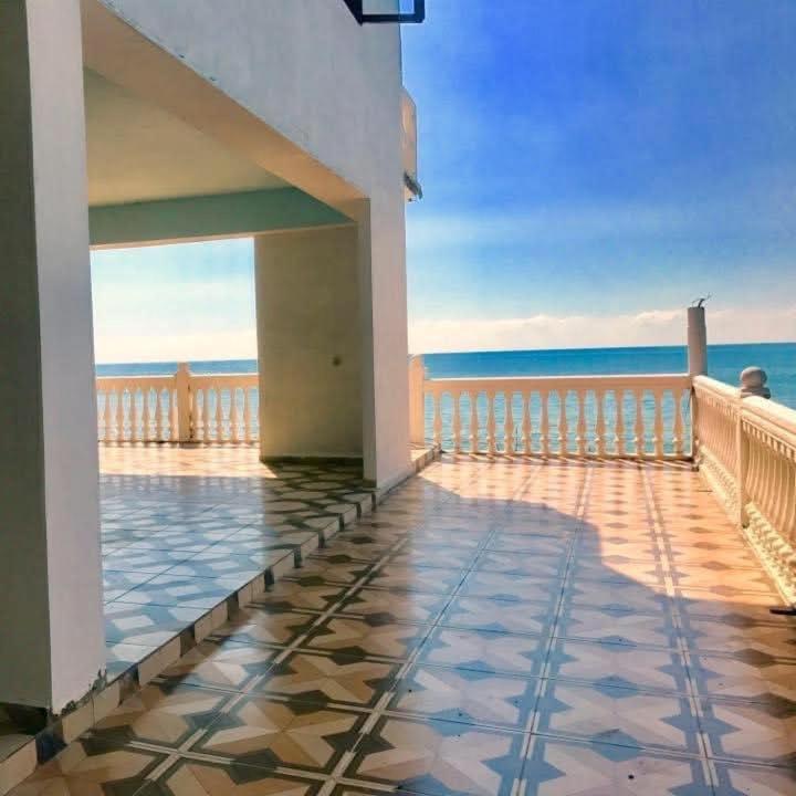 a balcony of a house with a view of the ocean at Mari House in Buknari