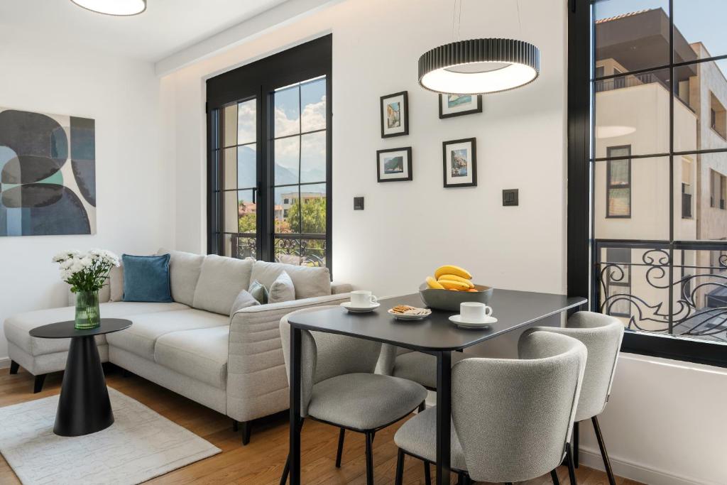 a living room with a couch and a table at One bedroom Belane Rezident in Tivat