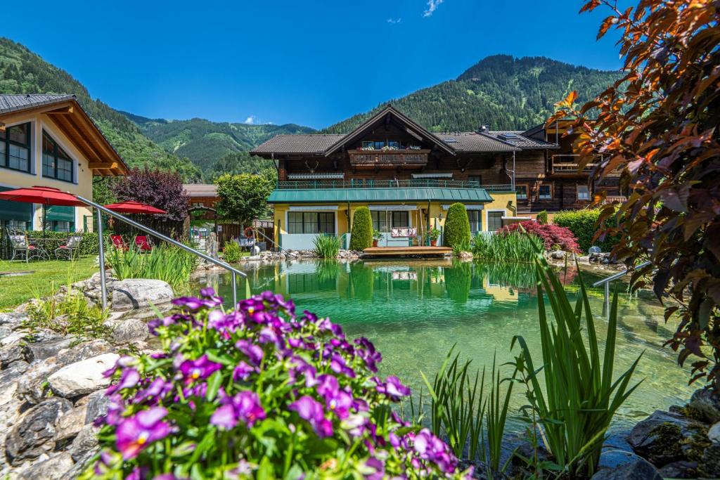 a house with a pond in front of it at Haus Katharina in Bad Hofgastein
